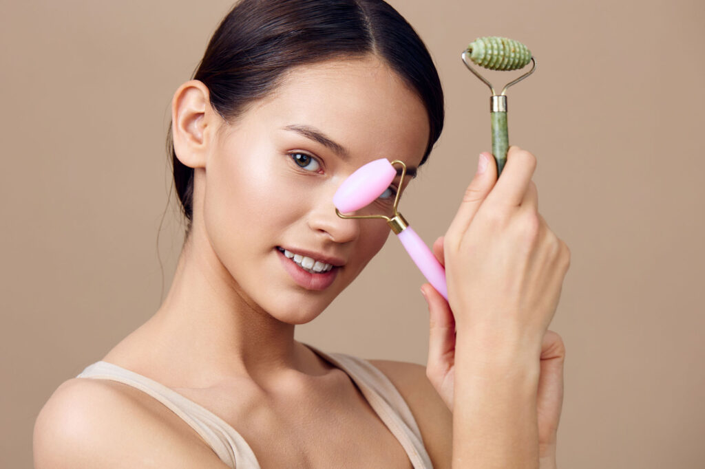 a young woman of asian descent holds facial roller 2025 02 05 01 54 45 utc