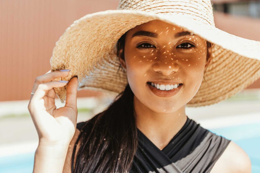 happy asian girl in swimsuit and straw hat 2024 11 17 06 52 01 utc